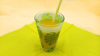 Glas mit Saft und Strohhalm